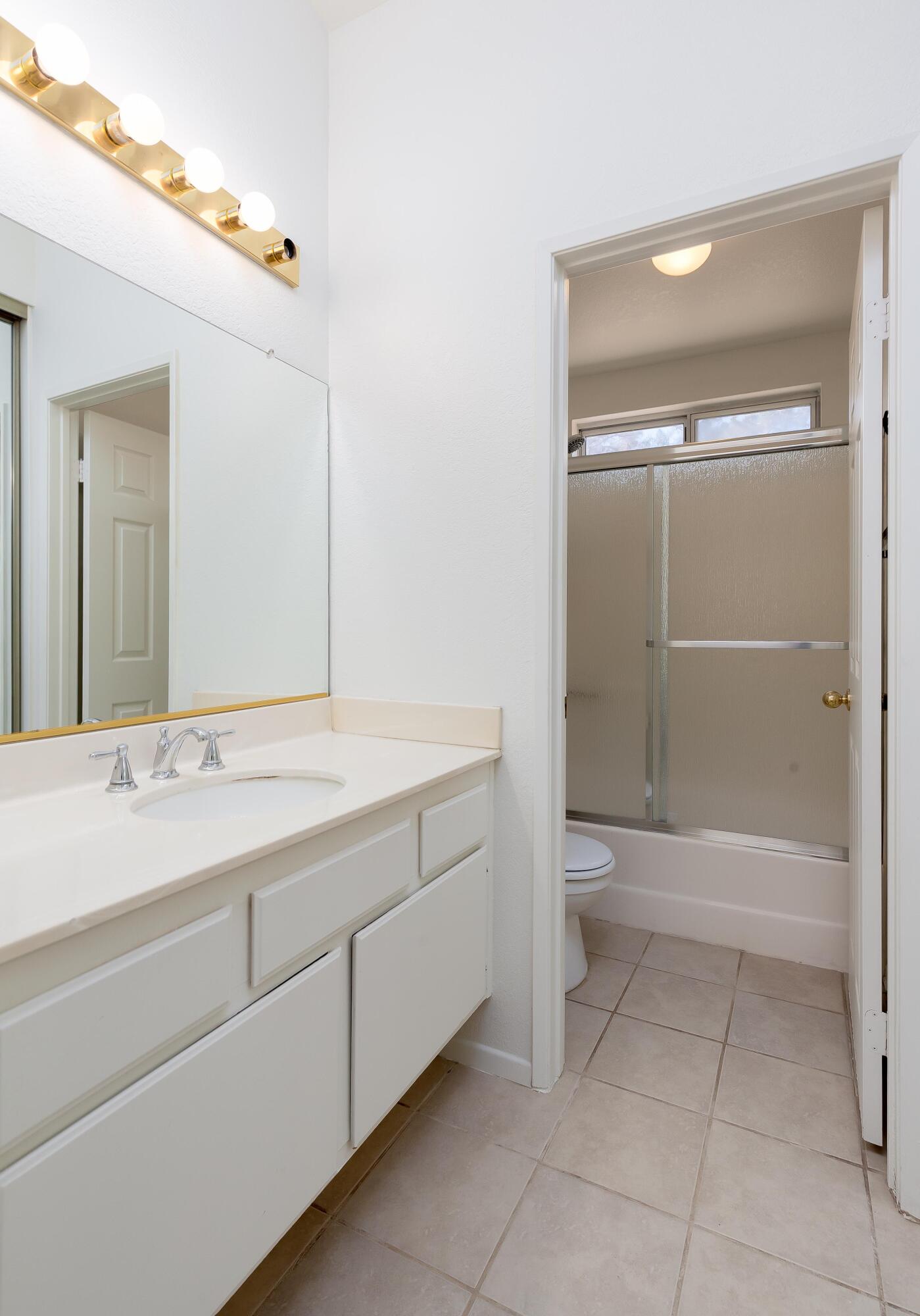 1628 Kings Road Palmdale, CA 93551 - Photo 13 of 22 a bathroom with a bathtub sink and toilet