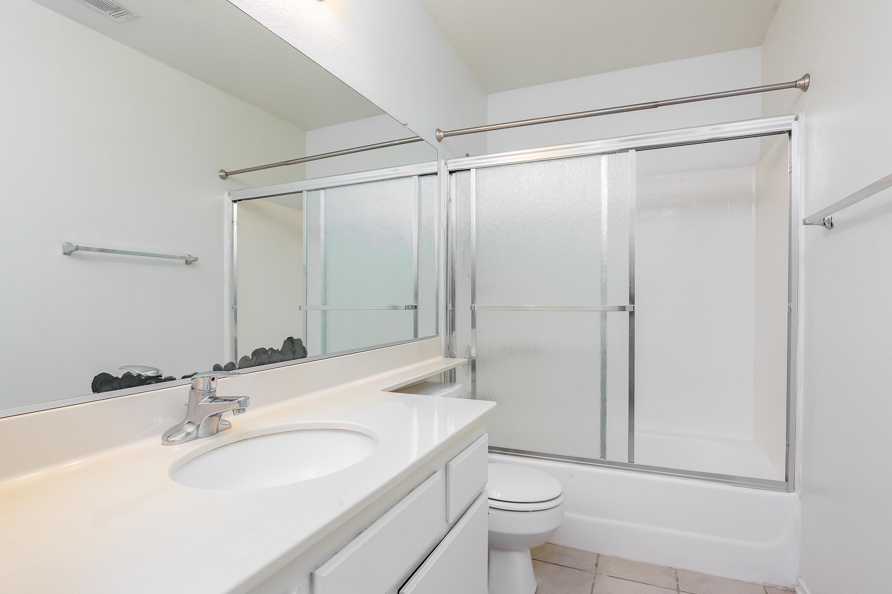1628 Kings Road Palmdale, CA 93551 - Photo 17 of 22 a bathroom with a sink toilet and shower