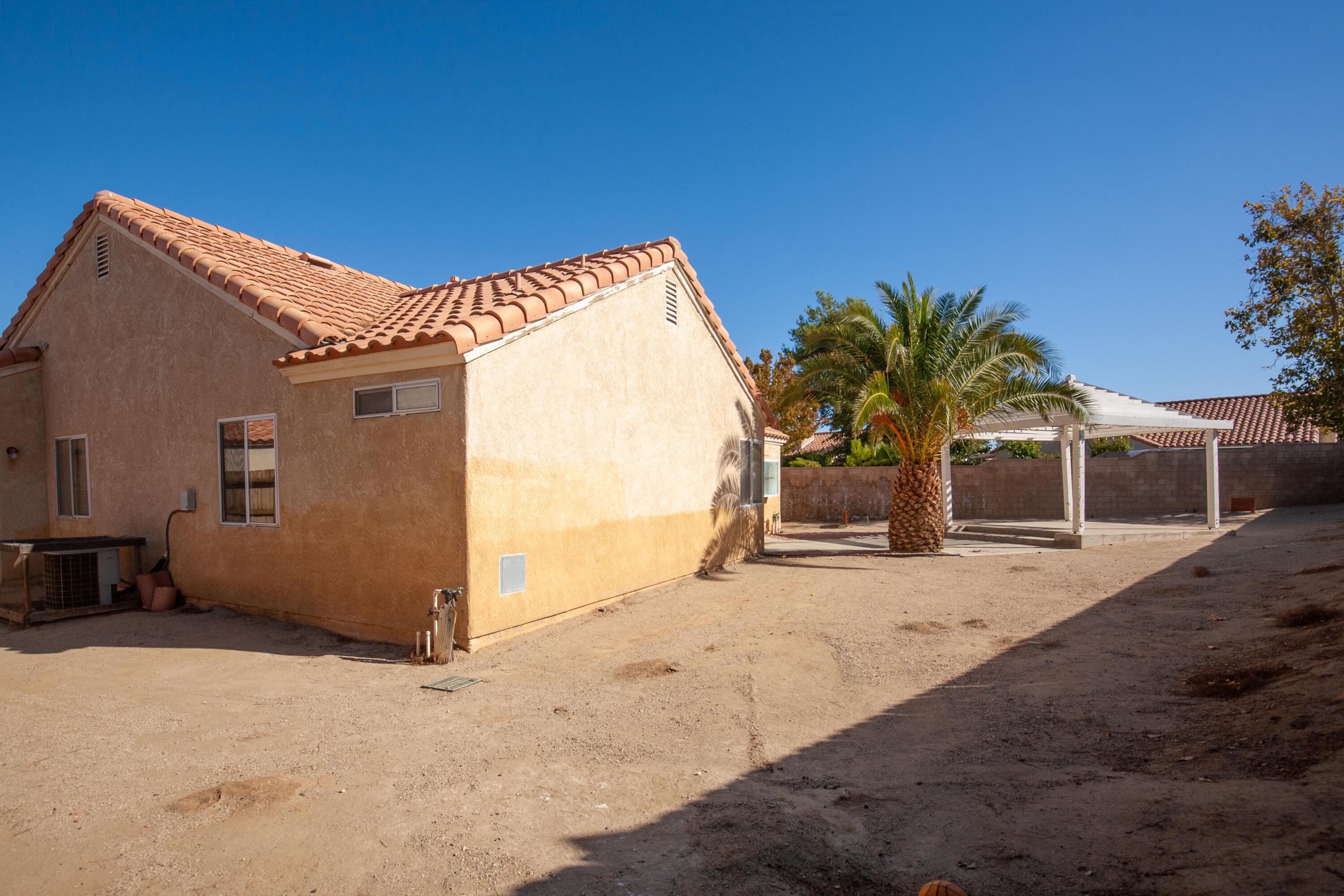 1628 Kings Road Palmdale, CA 93551 - Photo 21 of 22 a backyard of a house with seating space