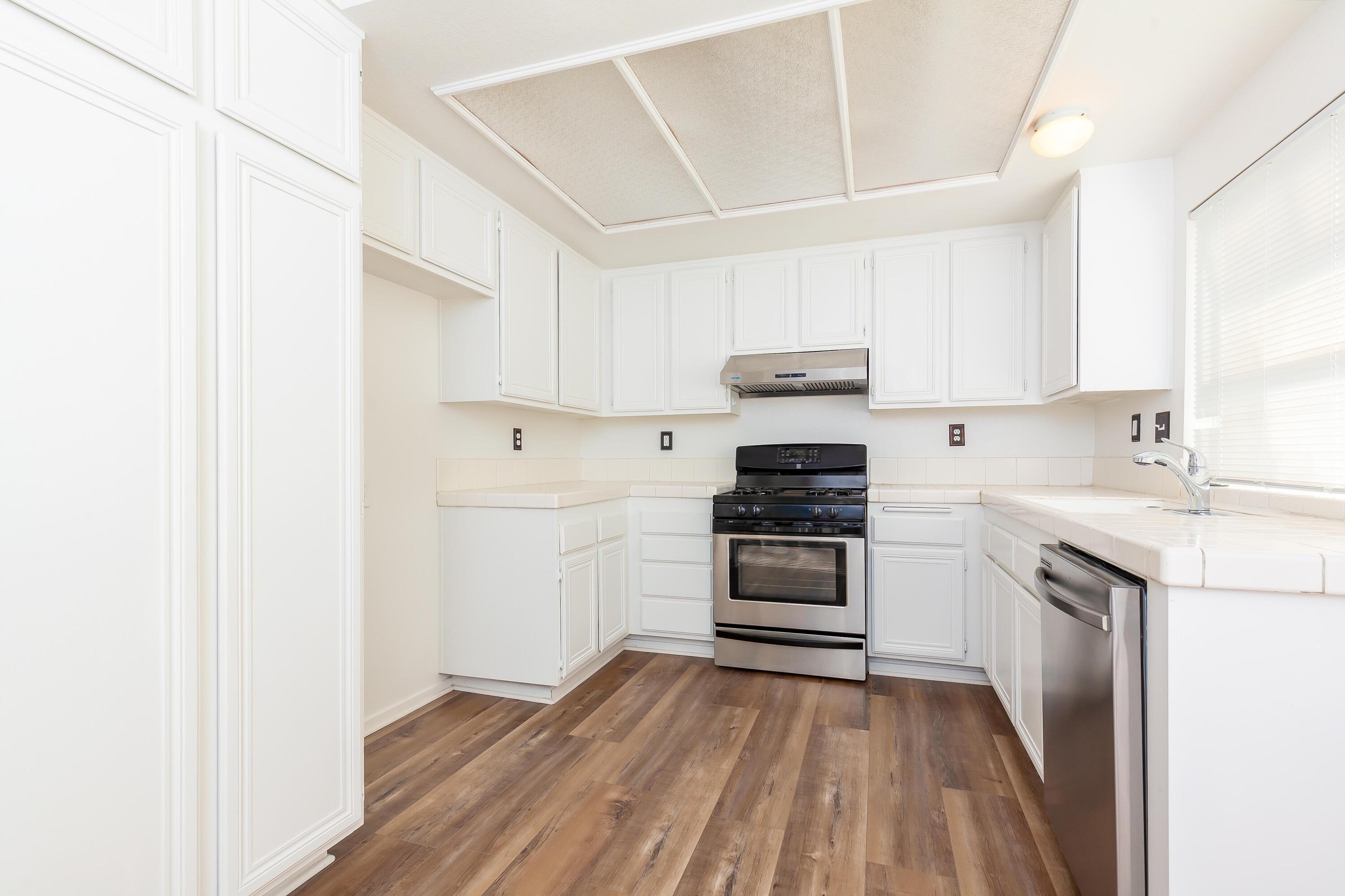1628 Kings Road Palmdale, CA 93551 - Photo 7 of 22 a kitchen with a sink and a stove top oven