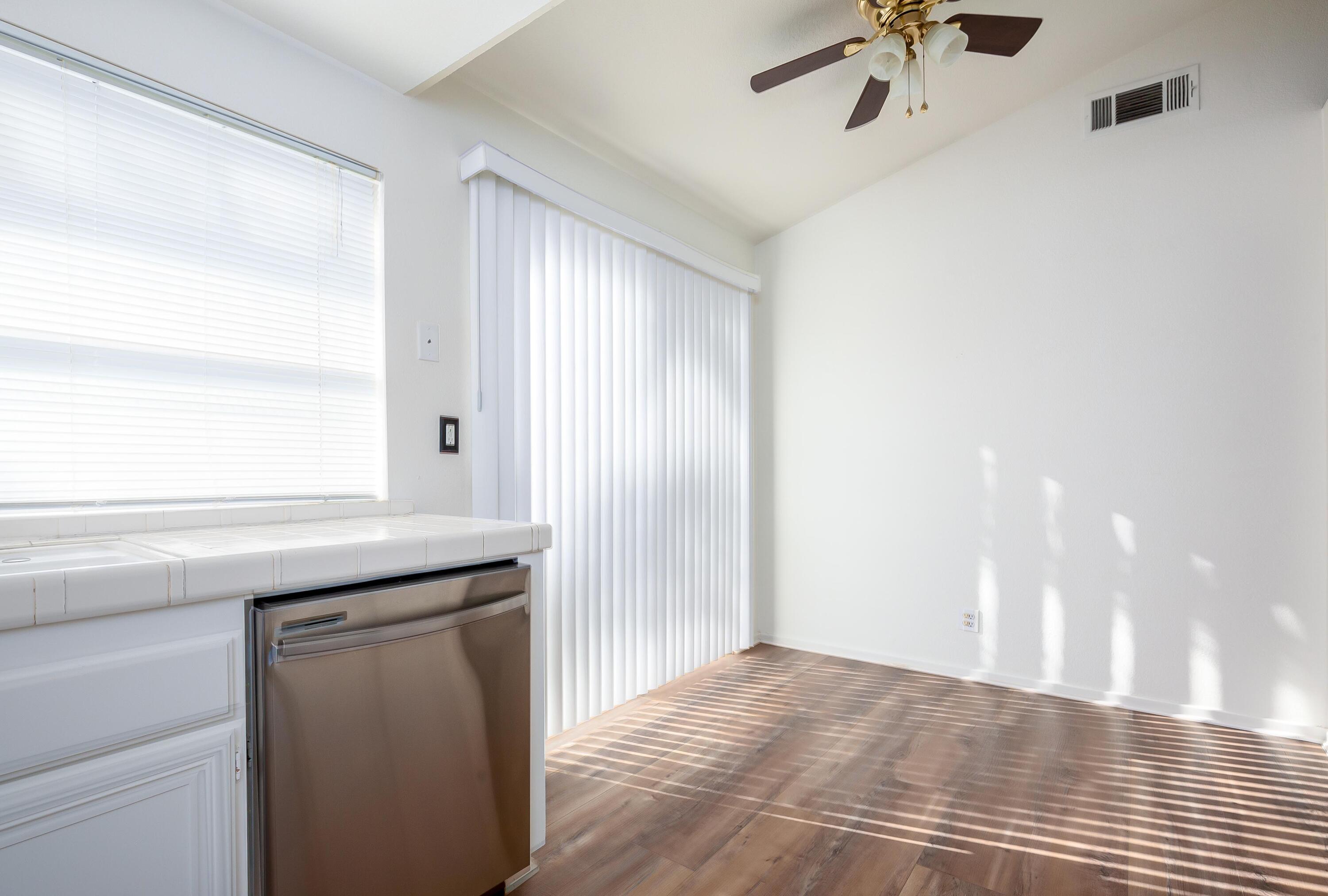 1628 Kings Road Palmdale, CA 93551 - Photo 9 of 22 a kitchen with a sink a refrigerator and window