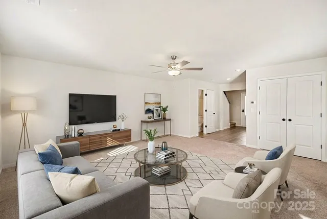 a living room with furniture and a flat screen tv