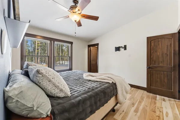 a bed sitting in a bedroom next to a window