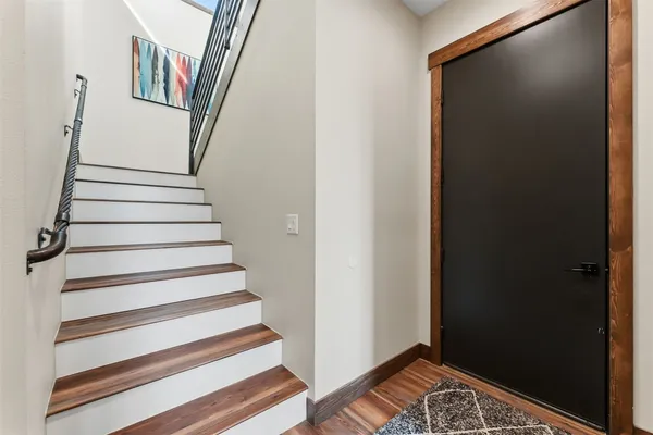 a view of entryway with wooden floor and stairs