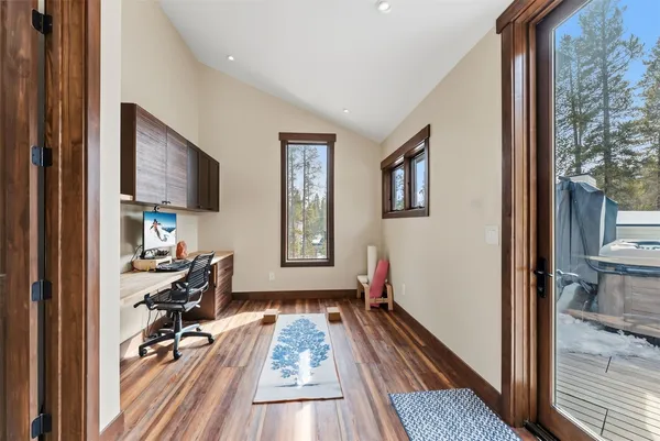 a view of a livingroom with wooden floor and furniture