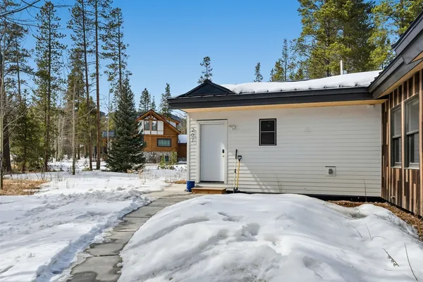 a view of a house with a snow in the yard