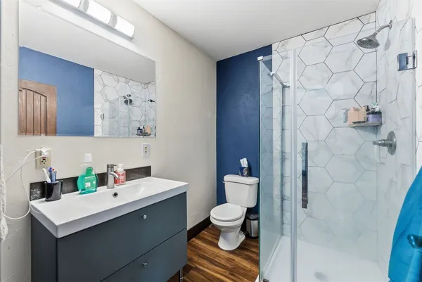 a bathroom with a sink toilet and shower