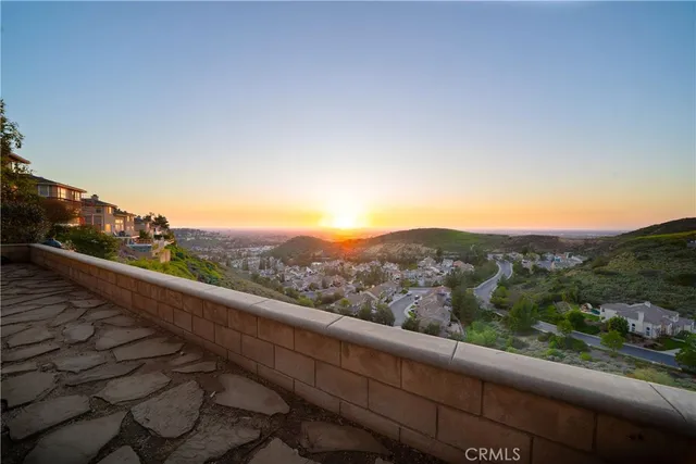 a view of a green field with mountains in the background