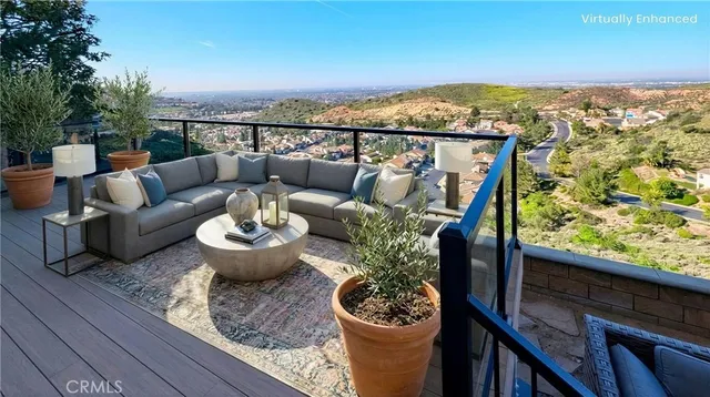 a view of a balcony with furniture and a potted plant