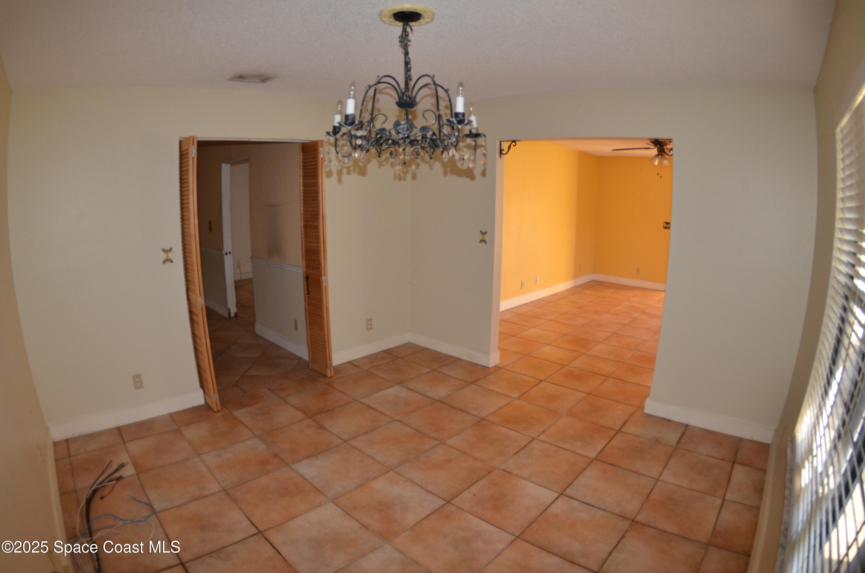 3600 Corey Road Malabar, FL 32950 - Photo 18 of 46 a view of a hallway with a chandelier