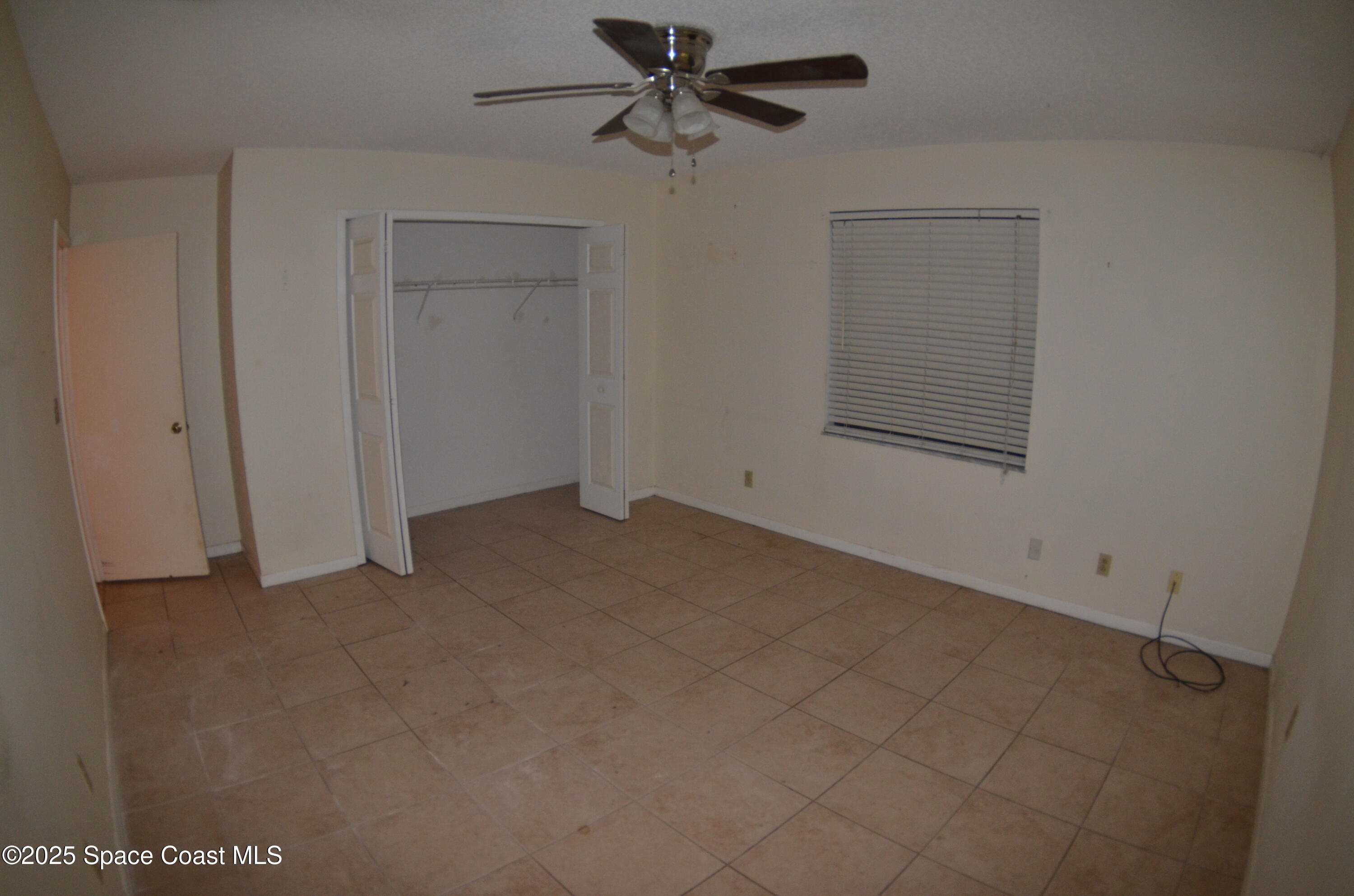 3600 Corey Road Malabar, FL 32950 - Photo 23 of 46 an empty room with chandelier fan