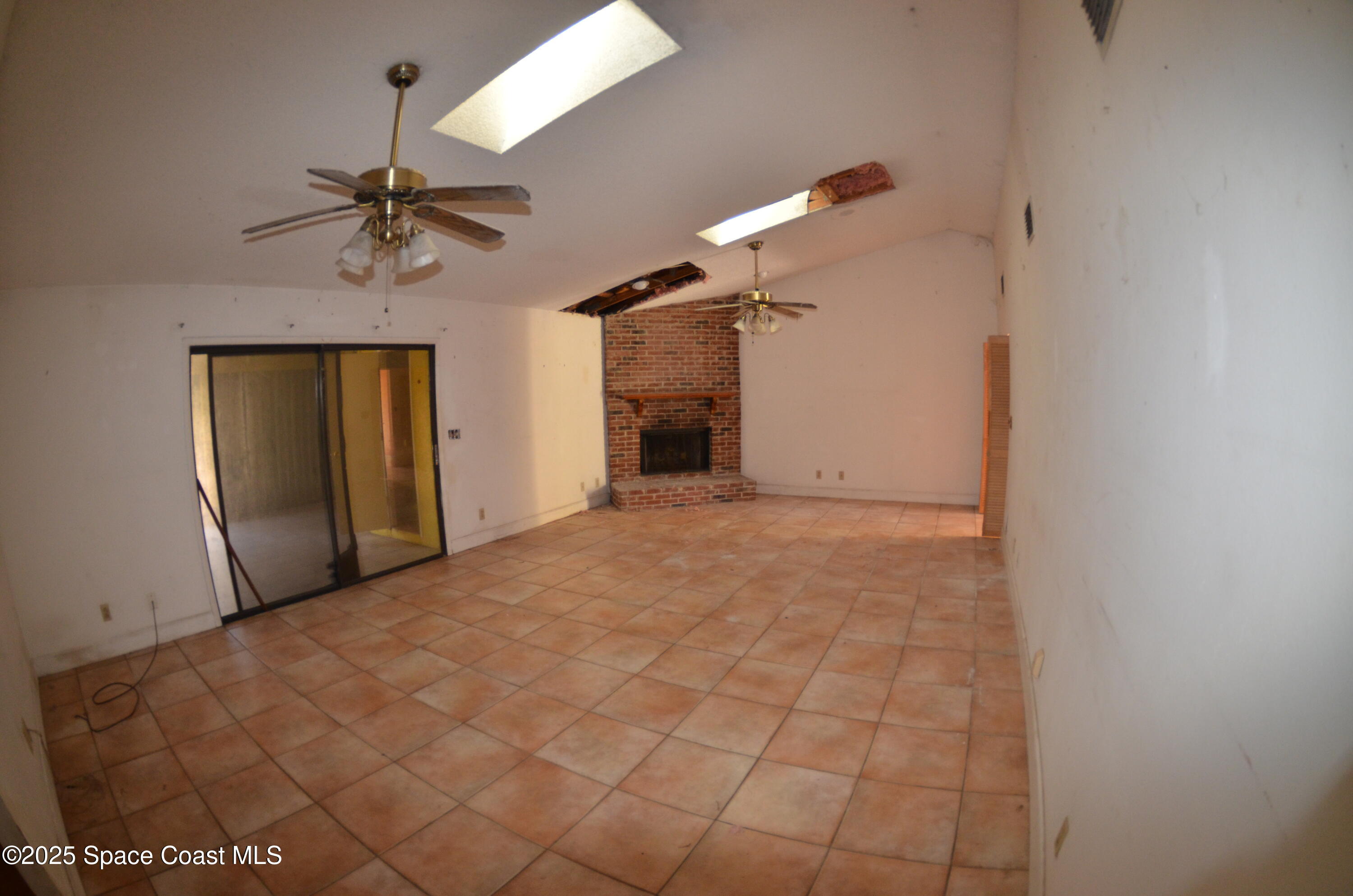 3600 Corey Road Malabar, FL 32950 - Photo 28 of 46 a view of a hallway with a chandelier fan and windows