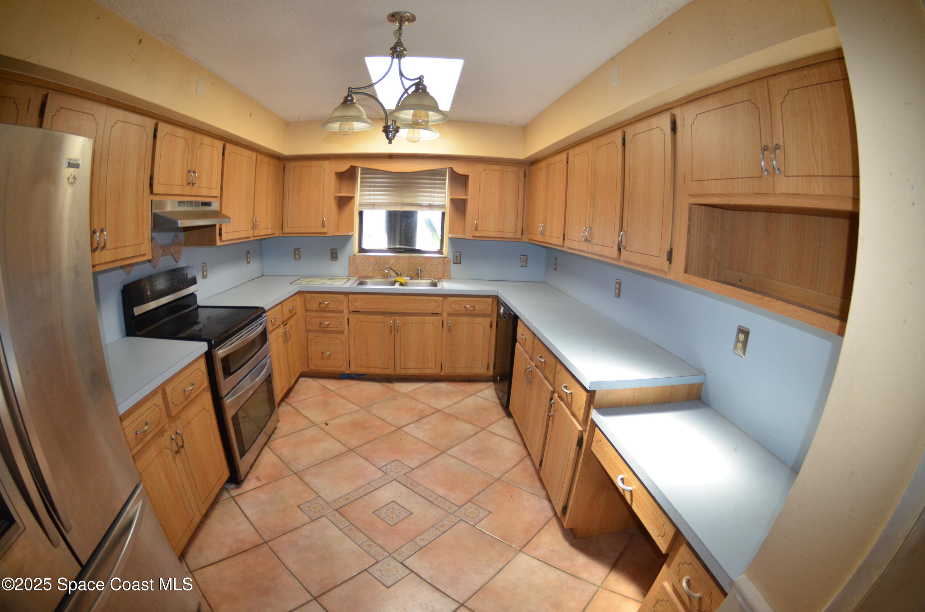 3600 Corey Road Malabar, FL 32950 - Photo 30 of 46 a kitchen with stainless steel appliances granite countertop a sink a stove cabinets and wooden floor