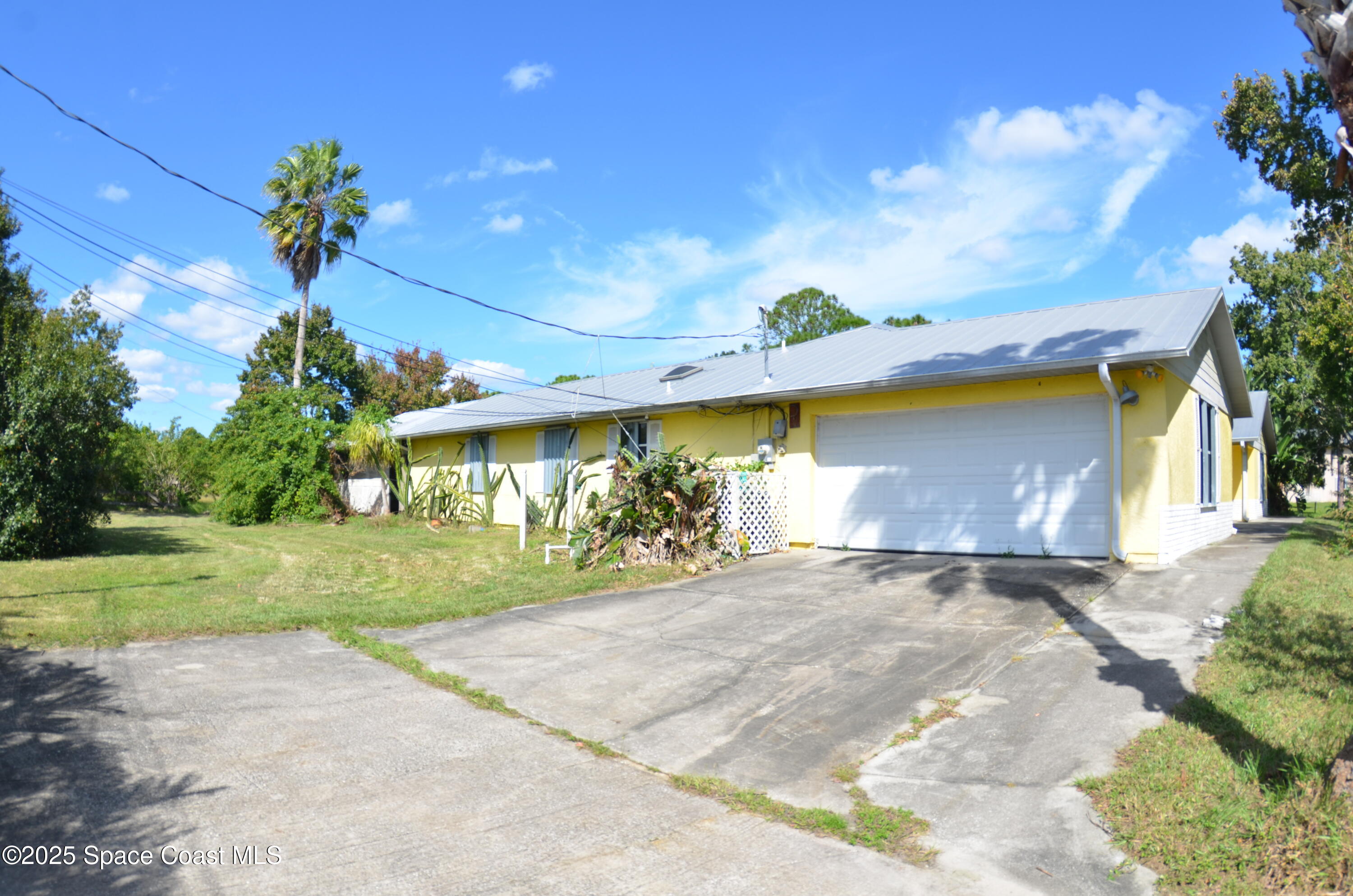 3600 Corey Road Malabar, FL 32950 - Photo 5 of 46 a view of a house with a yard and garage