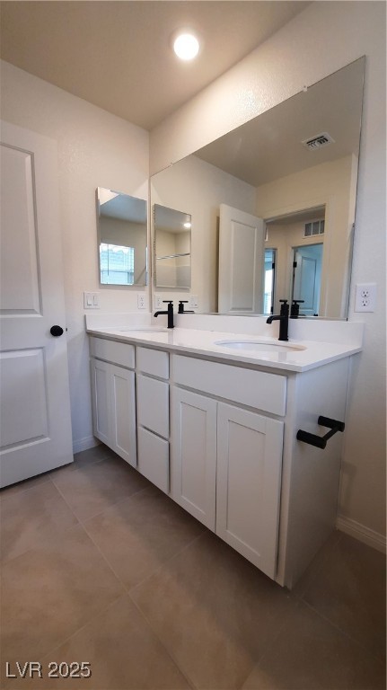 9084 Marigold Crk Street Las Vegas, NV 89113 - Photo 14 of 17 Bathroom with double vanity and light tile patterned flooring
