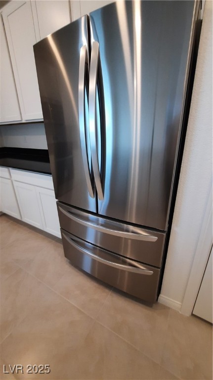 9084 Marigold Crk Street Las Vegas, NV 89113 - Photo 4 of 17 Kitchen view of freestanding refrigerator, dark countertops, and white cabinets