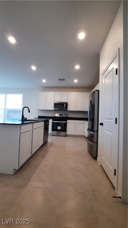 9084 Marigold Crk Street Las Vegas, NV 89113 - Photo 6 of 17 Kitchen featuring stainless steel range oven, dark countertops, white cabinetry, fridge, and recessed lighting