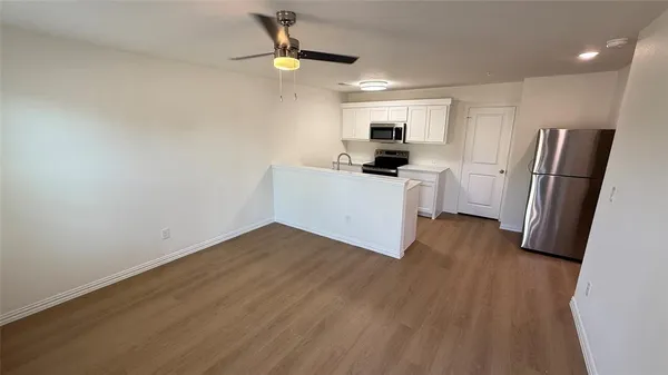 a kitchen that has a sink and a stove in it