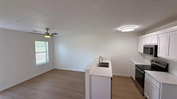 a view of an empty room and a window