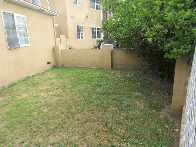 a view of a house with a wooden fence