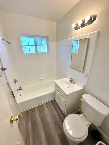 a white toilet sitting next to a bathroom sink and tub