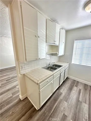 a kitchen with a sink stove and cabinets