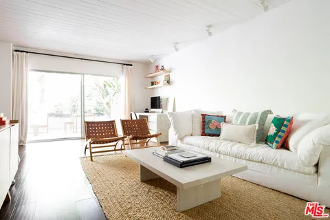 a living room with furniture and next to a window