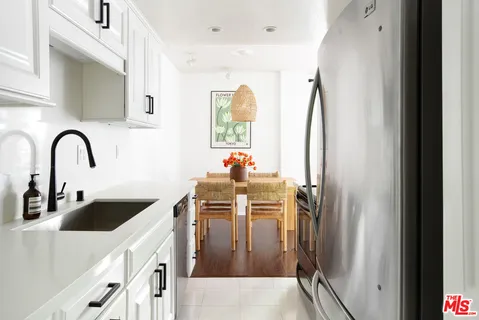 a kitchen with a sink a refrigerator and a stove