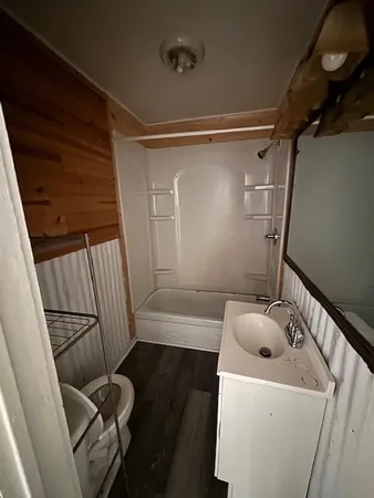 a bathroom with a tub and sink
