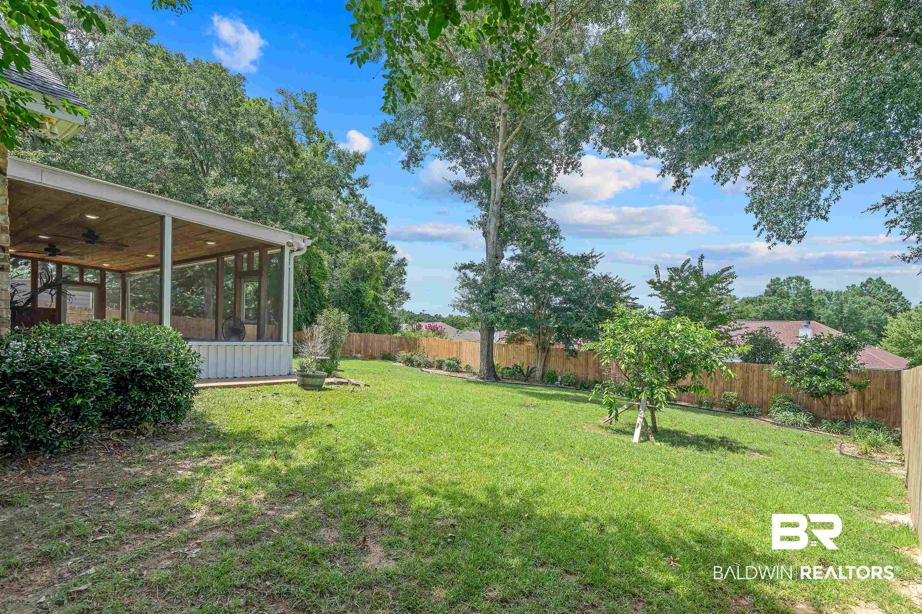 11097 Pontchartrain Loop Daphne, AL 36526 - Photo 5 of 28 Fenced backyard featuring a sunroom and a ceiling fan