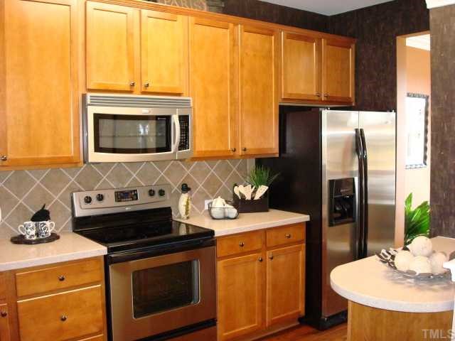 3102 Berkeley Street Raleigh, NC 27612 - Photo 4 of 7 Kitchen with maple cabinets and stainless steel appliances