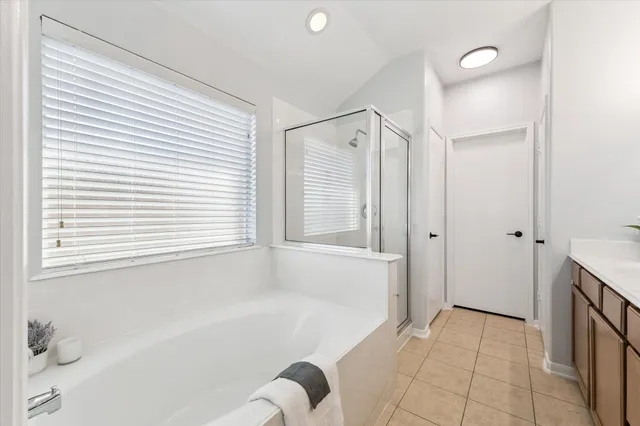 a bathroom with a bathtub and shower