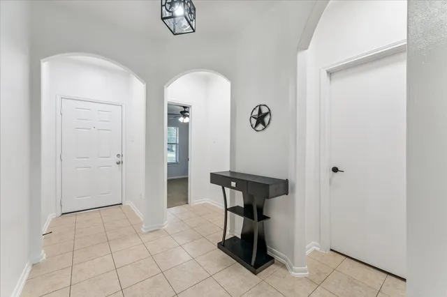 a view of an entryway with table and chair