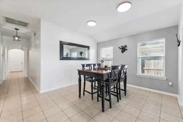 a view of a dining room with furniture and chandelier
