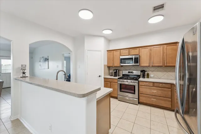 a kitchen with a sink stove and refrigerator