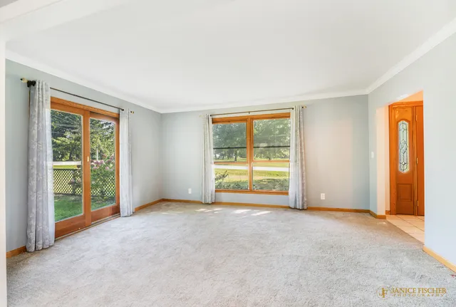an empty room with windows and balcony view