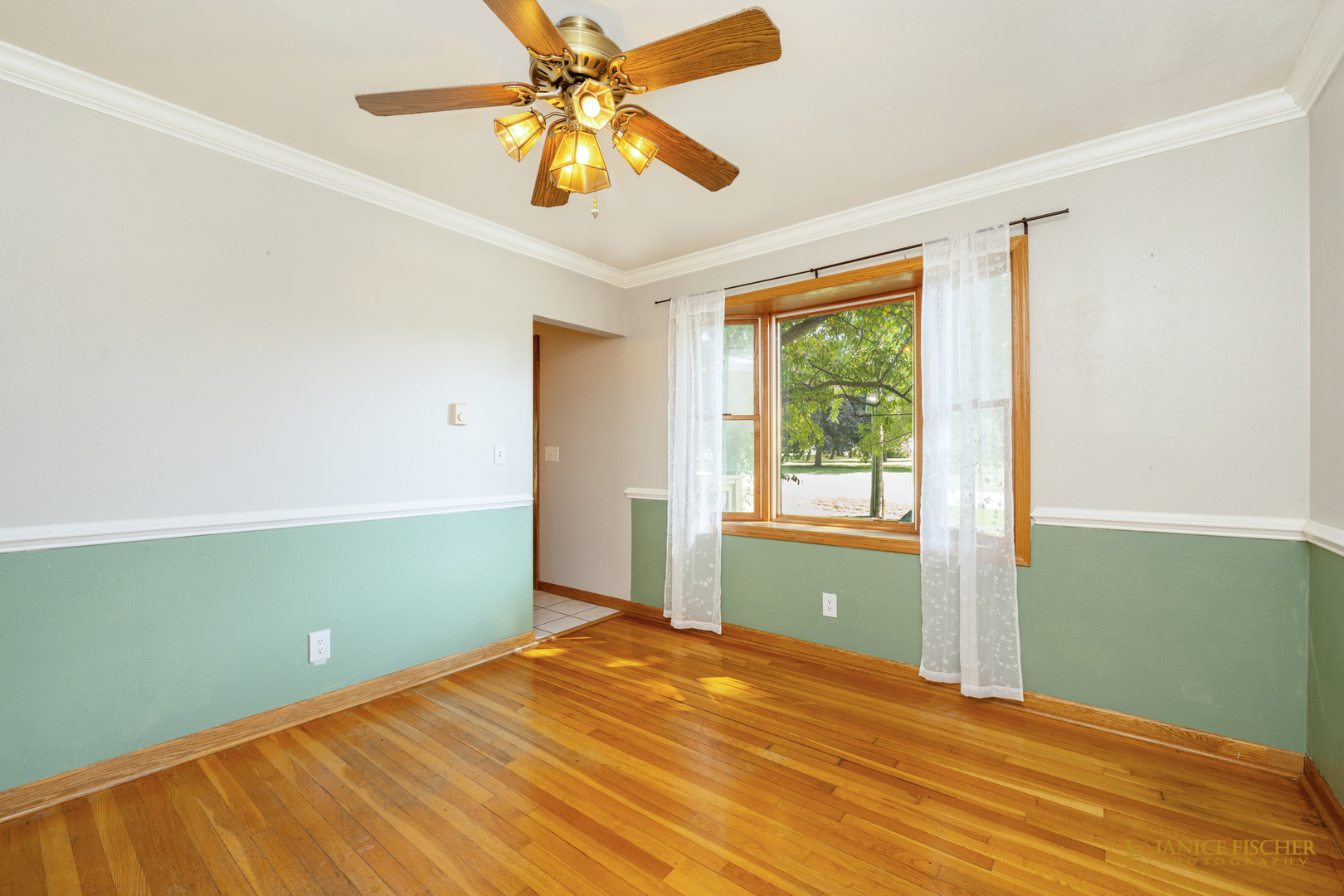 8488 Grange Hall Road Garden Prairie, IL 61038 - Photo 7 of 10 a view of a room with wooden floor and fan