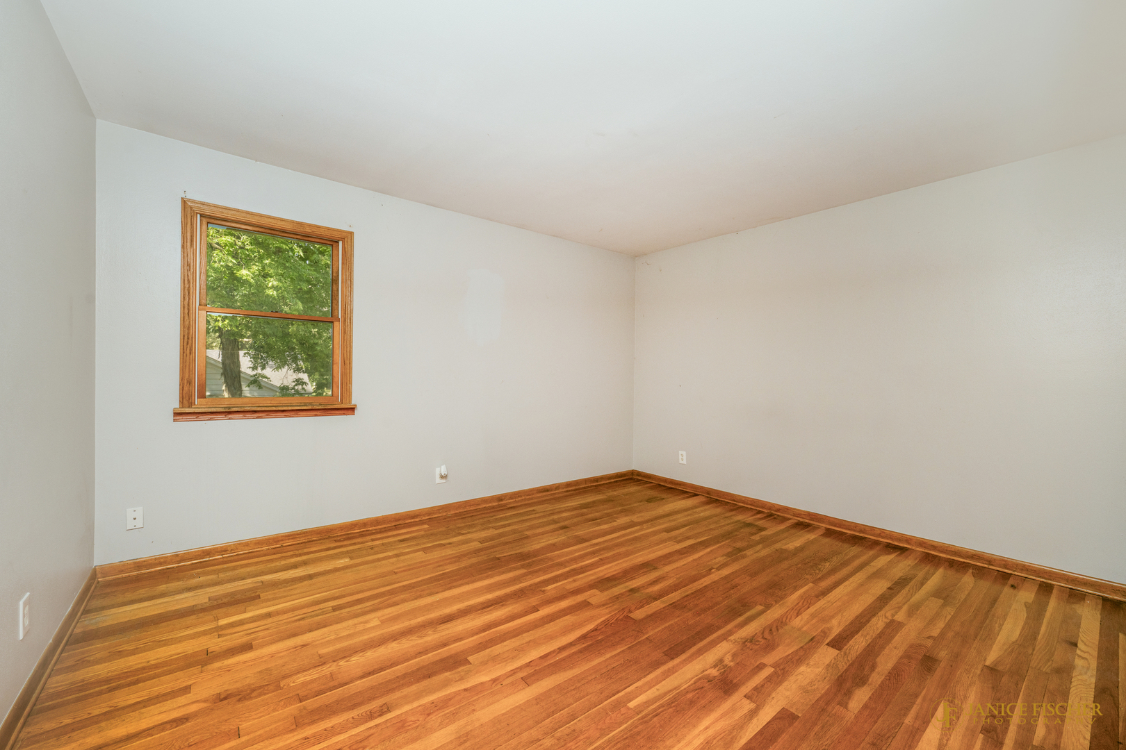 8488 Grange Hall Road Garden Prairie, IL 61038 - Photo 10 of 10 a view of an empty room with wooden floor and a window