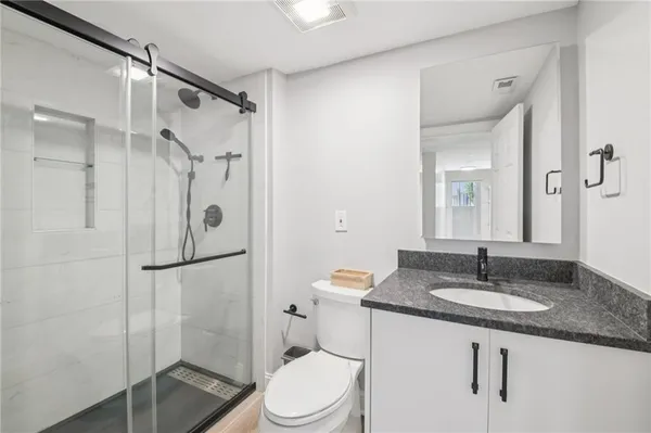 a bathroom with a sink toilet and shower