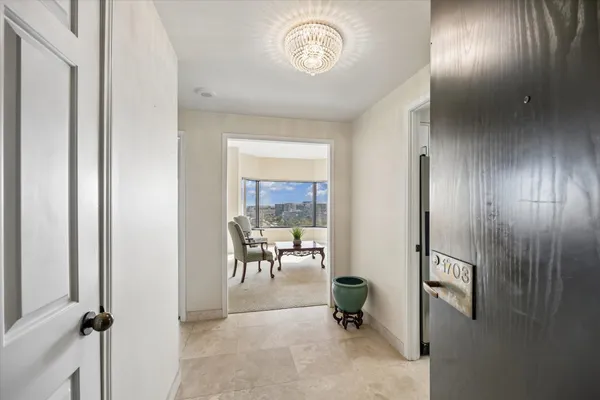 a living room with stainless steel appliances kitchen island granite countertop a refrigerator and a stove top oven