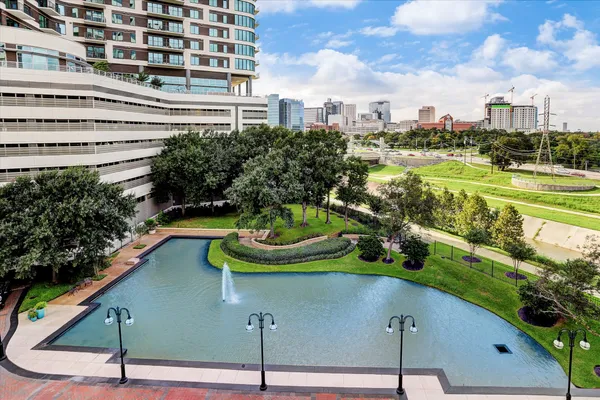 a living room with furniture a flat screen tv and a floor to ceiling window