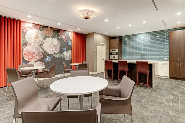 a view of a swimming pool with lawn chairs and plants