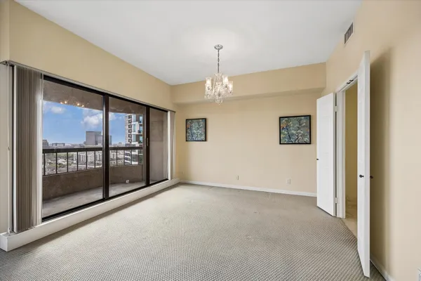 a view of a livingroom with a large window and couch