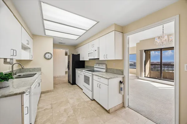 a kitchen with granite countertop cabinets stainless steel appliances and a counter space