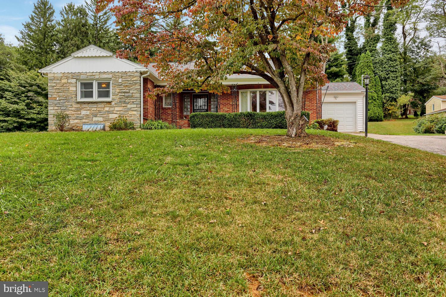 113 Country Club Road Red Lion, PA 17356 - Photo 1 of 31 a front view of a house with a yard and trees