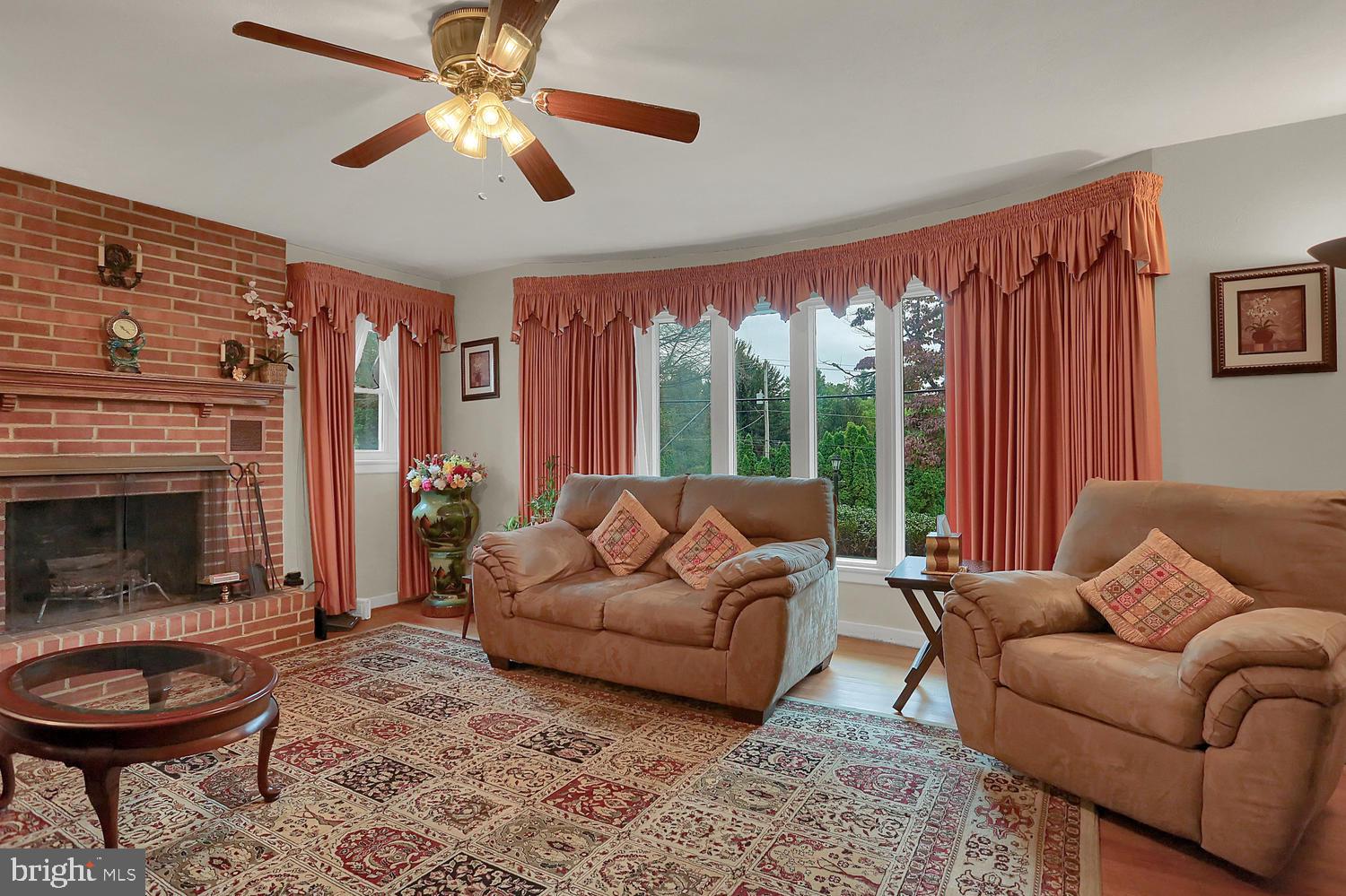 113 Country Club Road Red Lion, PA 17356 - Photo 2 of 31 a living room with furniture a fireplace and a large window