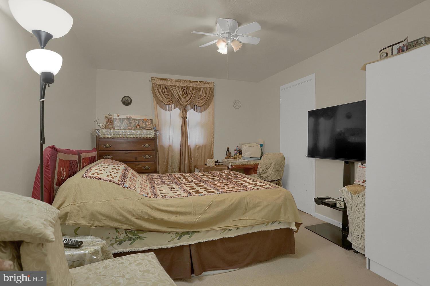 113 Country Club Road Red Lion, PA 17356 - Photo 16 of 31 a bedroom with a bed and a chandelier