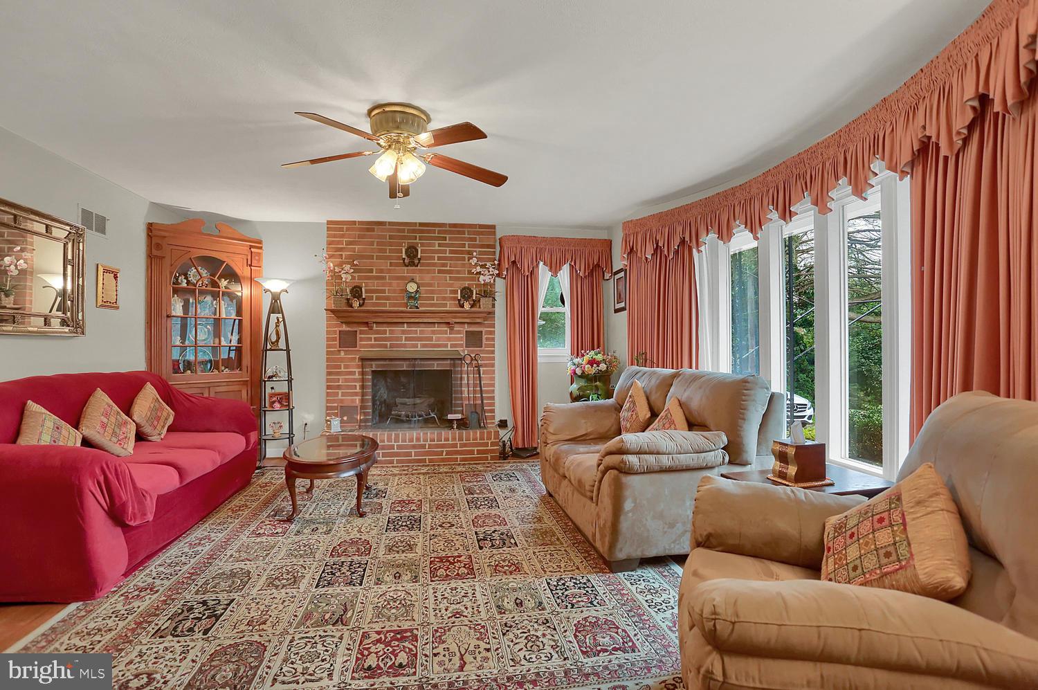 113 Country Club Road Red Lion, PA 17356 - Photo 3 of 31 a living room with furniture a ceiling fan and a fireplace