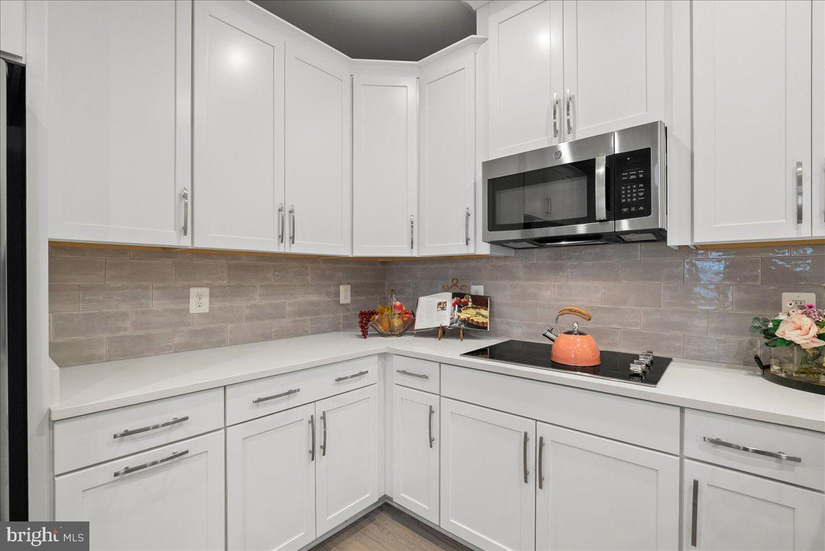 4128 Legato Road, Unit 53 Fairfax, VA 22033 - Photo 11 of 39 a kitchen with white cabinets stainless steel appliances and sink