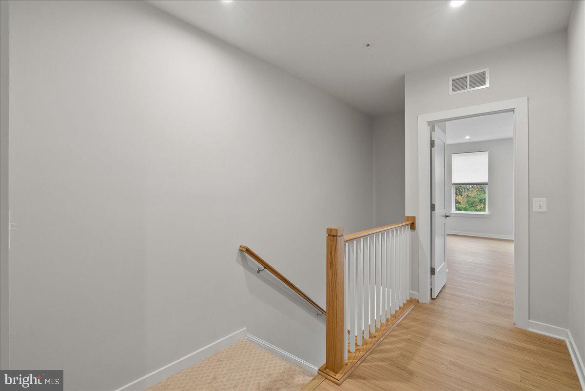 4128 Legato Road, Unit 53 Fairfax, VA 22033 - Photo 14 of 39 a view of a hallway with wooden floor and entryway